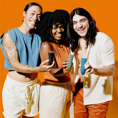 3 people smiling while holding body hair trimmers