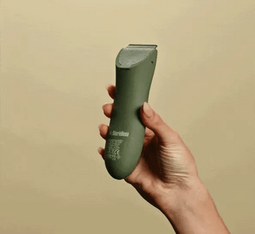 hand sliding comb onto hair trimmer's head