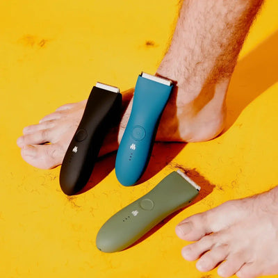 3 Meridian body hair trimmers next to man's feet